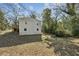 Exterior view of a home with a backyard and a wooden deck and stairs at 3261 Lowndes St, Atlanta, GA 30337