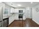 Modern kitchen with stainless steel appliances, granite countertops, and white cabinets at 3261 Lowndes St, Atlanta, GA 30337