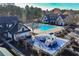 Aerial view of pool, playground, and clubhouse nestled among mature trees at 39 Telfair Ct, Acworth, GA 30101