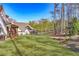 Scenic view of a spacious backyard with a screened porch and lush green lawn at 39 Telfair Ct, Acworth, GA 30101