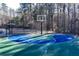 Community basketball court in a serene, wooded setting for recreational fun at 39 Telfair Ct, Acworth, GA 30101