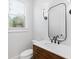 Stylish powder room featuring a wood vanity, modern fixtures, and natural light at 39 Telfair Ct, Acworth, GA 30101