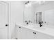 Bright bathroom featuring dual sinks, white cabinetry, matte black fixtures and a large frameless mirror at 39 Telfair Ct, Acworth, GA 30101