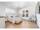 Bright bedroom with a light fixture, wood floors, and access to screened porch through glass doors at 39 Telfair Ct, Acworth, GA 30101