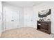 Neutral carpeted bedroom with white trim and doors, showcasing ample closet space and a bookshelf at 39 Telfair Ct, Acworth, GA 30101