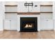 Elegant fireplace with built-in cabinets and rustic wood shelves, adding charm to the living space at 39 Telfair Ct, Acworth, GA 30101