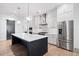 Modern kitchen with a large island, stainless steel appliances, and stylish pendant lighting at 39 Telfair Ct, Acworth, GA 30101