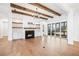 Bright living room featuring a fireplace, wood beam ceiling, and sliding glass doors to an outdoor space at 39 Telfair Ct, Acworth, GA 30101