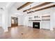 Bright living room boasts a cozy fireplace, built-in shelving, and beautiful wood beam ceiling at 39 Telfair Ct, Acworth, GA 30101