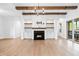 Cozy living room with a fireplace, open shelving, and sliding glass doors to the patio at 39 Telfair Ct, Acworth, GA 30101