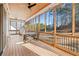 Relaxing screened porch with wood flooring, wood ceiling, and wooded view at 39 Telfair Ct, Acworth, GA 30101