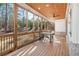 Cozy screened-in porch featuring natural wood and offering views of the wooded backyard at 39 Telfair Ct, Acworth, GA 30101