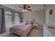 Comfortable bedroom featuring carpet, a ceiling fan, and two windows that fill the room with plenty of natural light at 610 Summertree Se Ct, Smyrna, GA 30126