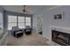 Bright bedroom featuring a fireplace, sitting area, and plenty of natural light from large windows at 610 Summertree Se Ct, Smyrna, GA 30126