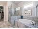 Bathroom featuring tiled shower, soaking tub, and modern fixtures at 10570 Grandview Sq, Johns Creek, GA 30097