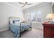 A secondary bedroom with gray carpet, white walls and window shutters, and a blue comforter at 10570 Grandview Sq, Johns Creek, GA 30097
