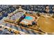 Aerial view of community pool with a play area and surrounding green space at 10570 Grandview Sq, Johns Creek, GA 30097