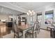 Bright dining room with modern chandelier flows into a living room and kitchen, perfect for entertaining at 10570 Grandview Sq, Johns Creek, GA 30097