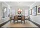 Formal dining room with modern chandelier, neutral paint, and large windows, perfect for entertaining at 10570 Grandview Sq, Johns Creek, GA 30097