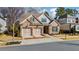 Charming two-story brick home with a two car garage and neatly landscaped front yard at 10570 Grandview Sq, Johns Creek, GA 30097