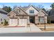 Charming home featuring a brick facade, two-car garage, and well-maintained landscaping at 10570 Grandview Sq, Johns Creek, GA 30097