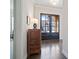 Entryway featuring hardwood floors, a dark wood dresser, and views of the front door at 10570 Grandview Sq, Johns Creek, GA 30097