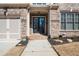 Close-up of the home's entryway with a covered porch and double doors at 10570 Grandview Sq, Johns Creek, GA 30097