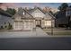 Charming brick home with a two-car garage and inviting front entrance at 10570 Grandview Sq, Johns Creek, GA 30097