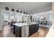 Kitchen island with stainless steel dishwasher offers an open concept to the living and dining room at 10570 Grandview Sq, Johns Creek, GA 30097