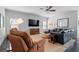 Spacious living room with dark floors, seating, and a large television and window at 10570 Grandview Sq, Johns Creek, GA 30097