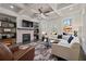 Bright living room with coffered ceiling, stone fireplace, and large windows overlooking the backyard at 10570 Grandview Sq, Johns Creek, GA 30097