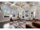 Light filled living room with coffered ceilings and large windows offers a relaxing atmosphere at 10570 Grandview Sq, Johns Creek, GA 30097