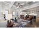 Open-concept living room with view to the kitchen features hardwood floors and a coffered ceiling at 10570 Grandview Sq, Johns Creek, GA 30097