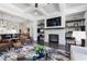 Living room with coffered ceilings, stone fireplace, built-in shelving, and hardwood flooring at 10570 Grandview Sq, Johns Creek, GA 30097