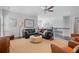 Open-concept living room with dark floors, leather seating, and stairs in the background at 10570 Grandview Sq, Johns Creek, GA 30097