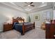 Comfortable main bedroom with tray ceiling, furnishings, and natural light at 10570 Grandview Sq, Johns Creek, GA 30097