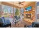 Covered patio with a brick fireplace, outdoor seating, and a ceiling fan at 10570 Grandview Sq, Johns Creek, GA 30097