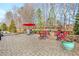 Inviting backyard patio with stone pavers, fire pit, seating, and lush landscaping at 10570 Grandview Sq, Johns Creek, GA 30097