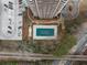 Overhead view of a building, parking lot, and community pool, bordered by trees, a road, and a railroad at 1501 Clairmont Rd # 1027, Decatur, GA 30033