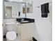 The bathroom has black and white tiling, vanity with black countertop, mirror, and chrome fixtures at 1501 Clairmont Rd # 1027, Decatur, GA 30033