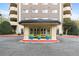 View of the building entrance featuring large pillars, planters, and a covered drop-off area at 1501 Clairmont Rd # 1027, Decatur, GA 30033
