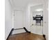 View of entryway with hardwood floors and a glimpse into the kitchen with black tiled backsplash at 1501 Clairmont Rd # 1027, Decatur, GA 30033