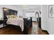 Well-lit main bedroom with a large bed, mirror, and tasteful decor on hardwood floors at 1501 Clairmont Rd # 1027, Decatur, GA 30033