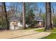 Back of home featuring brick exterior, wood decks, and well-manicured grounds at 3911 Ivy Ne Rd, Atlanta, GA 30342