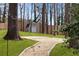 Well-maintained backyard featuring a charming storage shed and pea gravel pathway at 3911 Ivy Ne Rd, Atlanta, GA 30342
