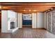 Finished basement area featuring laminate flooring, a fireplace, exposed wood beams, and an open floor plan at 3911 Ivy Ne Rd, Atlanta, GA 30342