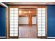 Finished basement area featuring laminate flooring, exposed wood beams, blue accent wall, and an open floor plan at 3911 Ivy Ne Rd, Atlanta, GA 30342