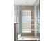 Updated tile shower with glass door and glass block window for natural light at 3911 Ivy Ne Rd, Atlanta, GA 30342