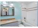 This bathroom features tile shower, tan granite, undermount sink, light blue paint, and modern fixtures at 3911 Ivy Ne Rd, Atlanta, GA 30342