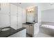 Bathroom with double sink vanity, soaking tub, tiled floors and plenty of cabinet storage at 3911 Ivy Ne Rd, Atlanta, GA 30342